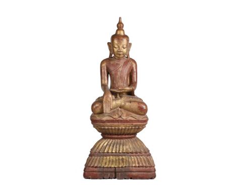 A LARGE WOOD THAI BUDDHA20TH CENTURYseated and with gilding a red lacquer125cm high Condition Report: splits and losses to ba