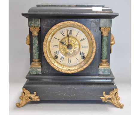 A Victorian mantel clock, in blackened marble, with lion mask handles, 31cm x 31cm