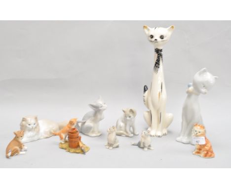 A Lladro figure of a cat and other cats, the tallest 38.5cm high