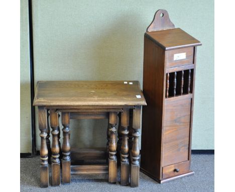 An nest of three oak rectangular tables and a stained oak stick stand with drawer, the largest table 56cm wide