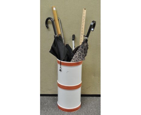 An Italian ceramic stick stand with a collection of umbrellas, a litter grab and other items, the stand 47.5cm high