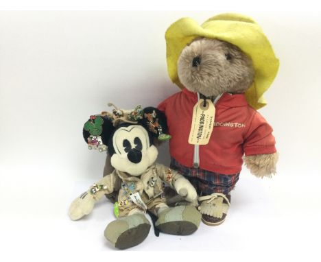 A Paddington Bear soft toy with original label together with a vintage Mickey Mouse soft toy with attached metal badges (2).