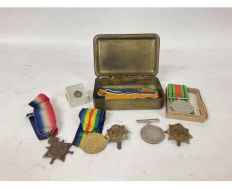 WW1 &amp; 2 medals and pins consisting of WW1 army service corps cap badge, Victory medal etc stored In a Christmas 1914 tin