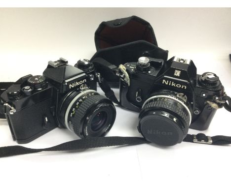Two unboxed Nikon cameras and a collection of vintage cameras.