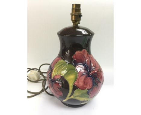 A Moorcroft lamp of baluster from in hibiscus pattern, approx height 31cm. No shade.