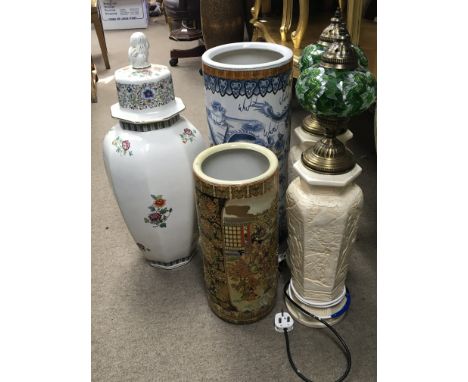 Two Chinese stick stands a pair of lamps and a large decorative vase.