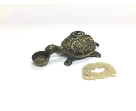 A jade pendant and a brass oil lamp in the form of a tortoise (2).