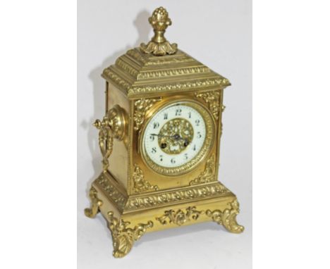 A 19th century brass mantel clock with enamel dial and French movement. H35cm