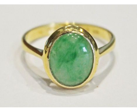 A 14 ct gold jade cabochon ring, marked '14K' & '585', the cabochon approx. 1.1cm x 1cm, gross wt. 3g, size O.