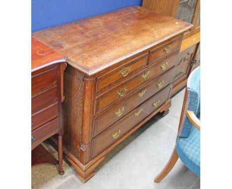 A Georgian crossbanded oak chest of drawers with brass handles and ogee bracket feet. W109cm D54cm H86cm