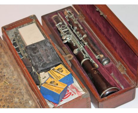 A French rosewood clarinet inscribed 'Brevete Triebert A Paris'with box of musical instrument spares.