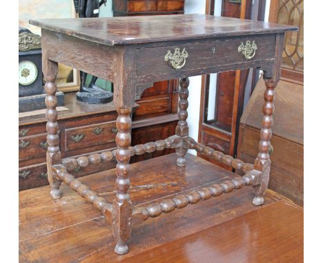 An oak side table with bobbin legs and single drawer. L82cm D59cm H73cm