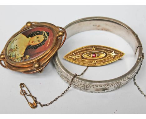A mixed lot comprising a hallmarked 9ct gold brooch set with a ruby and two half cut pearls, a hallmarked silver bangle and a