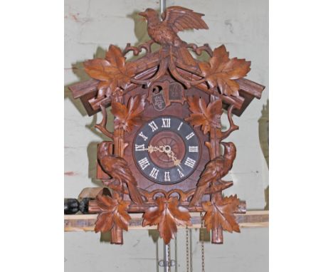 A carved Black Forest cuckoo clock. H44cm W36cm