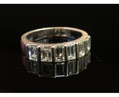 An 18ct white gold ring set with six baguette cut diamonds, size N, 5.7g