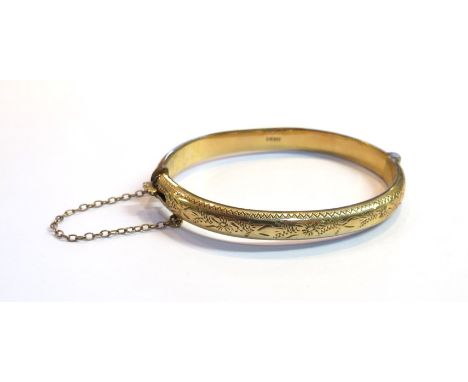 A 9ct gold engraved stiff hinge bangle, 8.9g