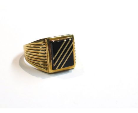An 18ct gold signet ring, rectangular black onyx with four gold band detail, size V/W, 7.3g
