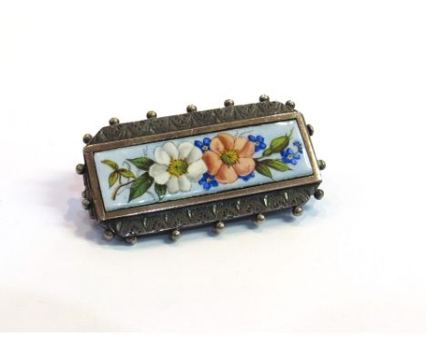 A white metal brooch with floral ceramic panel 