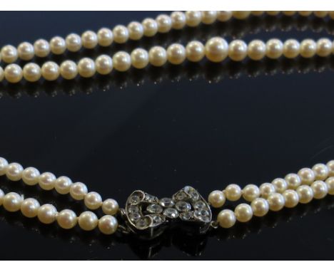 A double strand cultured pearl necklace with fine silver paste bow clasp, longest row 40cm long