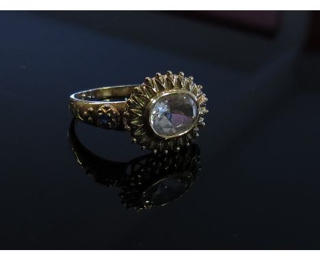 A 9ct gold ring the oval clear stone in fancy mount with sapphire set shoulders, size R, 3.7g