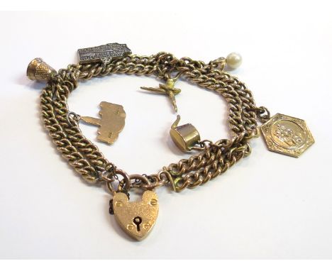 A 9ct gold bracelet hung with various charms including ballerina pearl and thimble, 40g