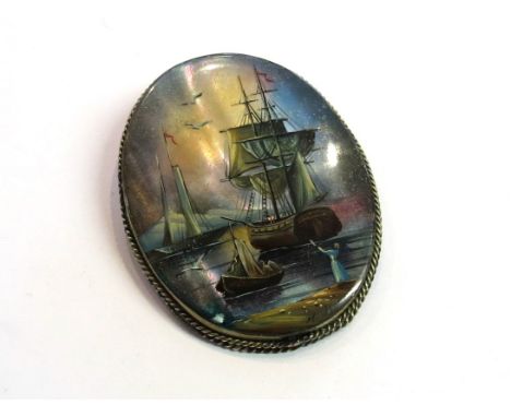 A silver mother-of-pearl brooch featuring a signed handpainted maritime scene of young girl waving to a ship