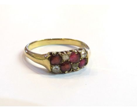 A gold diamond and garnet set ring, unmarked, size R, 4g