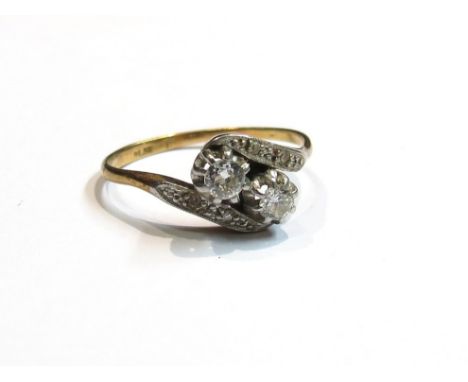 An 18ct gold platinum set diamond crossover ring, size N, 2.3g