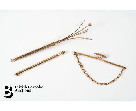 A 9ct yellow gold toothpick, 9ct gold swizzle stick and 9ct gold tie-slide, 9.2 gms.&nbsp;