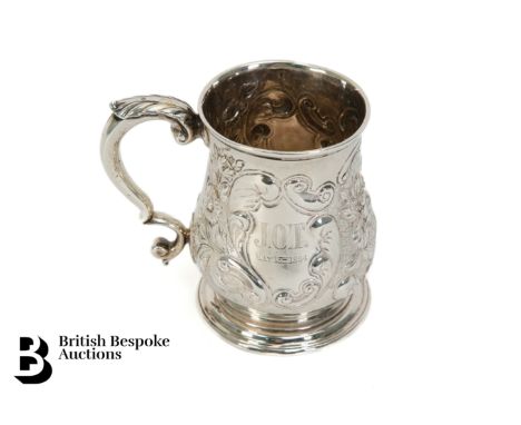 A George II silver christening mug, baluster form decorated with floral sprays, engraved J.O.T May 15th 1894 to front, London