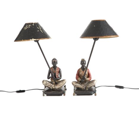 Pair of lacquered and gilded bronze table lamps depicting "ORIENTAL WOMAN AND MAN SITTING ON A CUSHION". Late 19th-early 20th