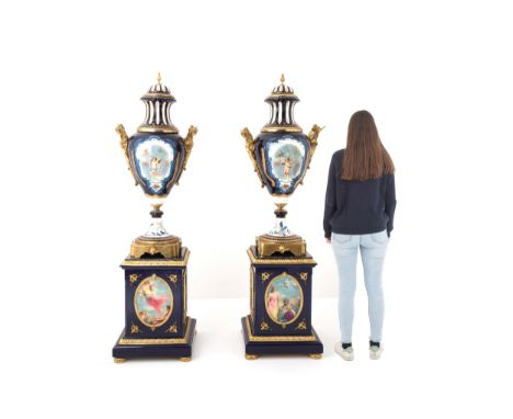 Pair of blue porcelain vases. Lacquered wooden bases with black marble tops with gilded bronze finishes. 20th century. Defect