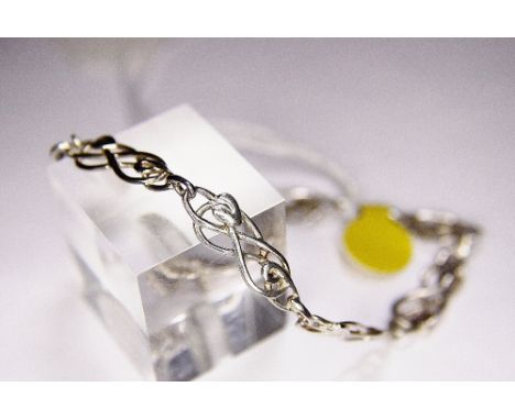 SILVER BRACELET. Sterling silver Celtic tulip bracelet with safety chain