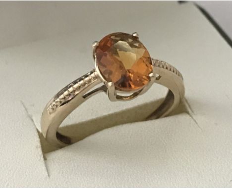 A 9ct gold dress ring set with 1.7ct oval Madeira Citrine. With patterned shoulders. Size N. Total weight approx. 2.1g.