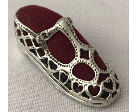 A miniature 925 silver pin cushion in the shape of a child's Mary Jane shoe with red velvet interior Approx. 4cm long. Total 