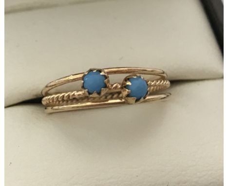 Ladies gold tri band style dress ring set with 2 turquoise stones. Tests as 22ct gold. Size K.  Selling on behalf of Hillside