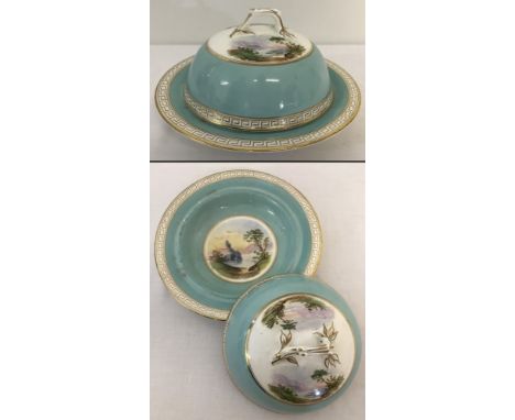 An Antique ceramic muffin dish with hand painted scenes to inside dish and lid. Gilt Greek key design to border and branch sh