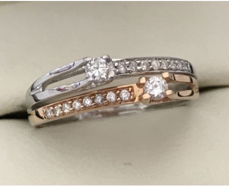 A modern design dual colour 18ct gold and diamond dress ring. White and rose gold. Total of 18 diamonds all round cut. Size L