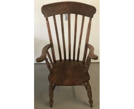 A Victorian stick back farmhouse carver chair with turned detail to legs and arm spindles.  Approx. 119cm.