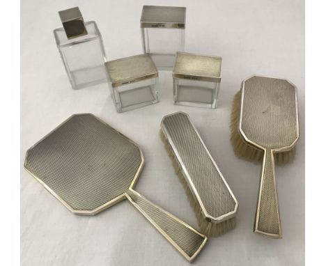 An Art Deco silver dressing table set with engine turned decoration by Asprey and Co. London. Comprising: 3 cosmetic/powder j