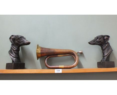 A pair of cast metal greyhound bookends plus a brass and copper bugle