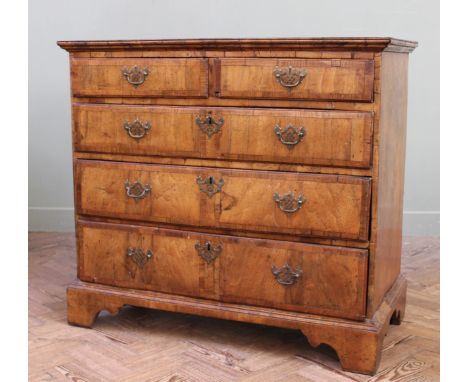 A George I walnut veneer chest of five drawers of very good original colour, with quarter veneered cross banded top, cross ba
