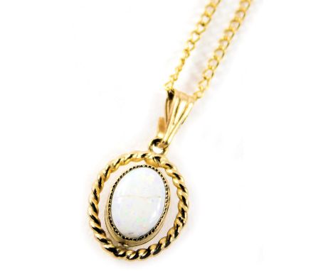 A 9ct gold opal pendant and chain, the oval opal with rope twist border, 1.5cm wide, on a fine link neck chain, 44cm long, 1.