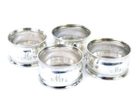 A set of four George VI silver napkin rings, each with a reeded border, bearing the initial M, Birmingham 1938, 1.61oz. 