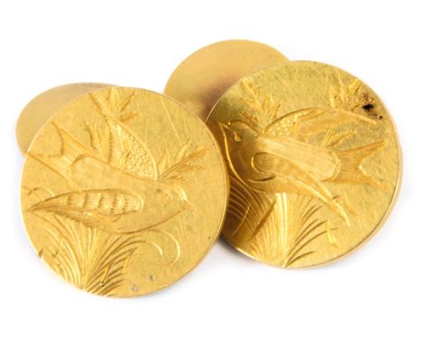 A pair of Victorian cufflinks, each of oval form with engine engraved decoration of swallows in vines, with steel chain link,