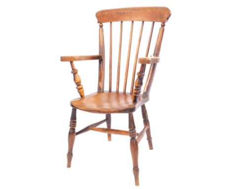 A late 19thC elm and beech stick back arm chair, with an arched rail and turned legs, 99cm high, 56cm wide, 46cm deep. 