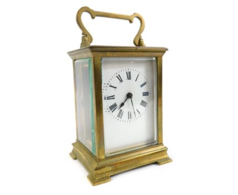 A French brass carriage clock, rectangular enamel dial bearing Roman numerals, single barrel movement, the case of convention