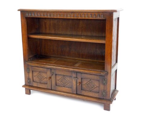 A reproduction oak open bookcase, with one adjustable shelf above arrangement of two cupboards, on stile feet, 92cm high, 102