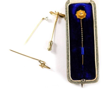 Four stick pins, comprising a 9ct gold A stick pin set with tiny diamond, 0.8g, a 15ct gold topped and diamond stick pin, and