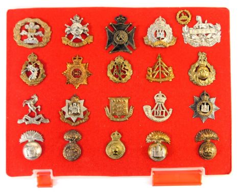 A group of military cap badges, to include Royal Welsh Fusiliers, Royal Army Dental Corps, Army Catering Corps, Army Ordnance